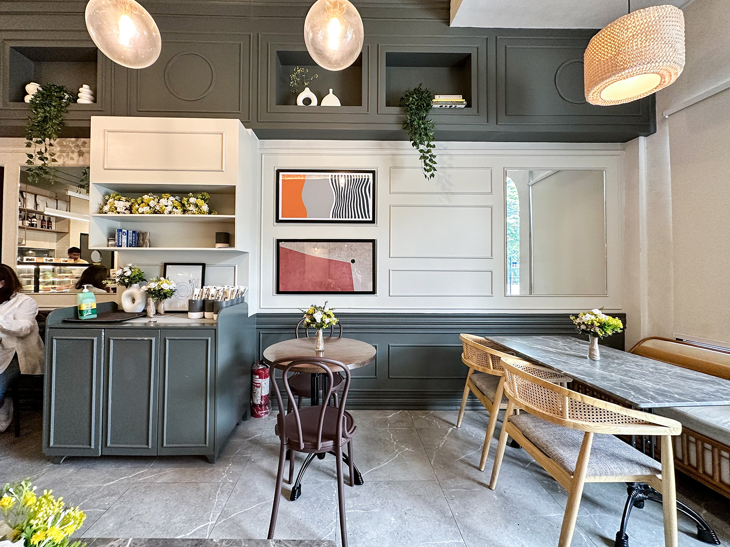 Interior wall detail with teal cabinetry and artwork